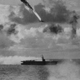 A Japanese dive bomber goes down in flames while attacking the escort carrier USS Kitkun Bay (CVE-71). (US Navy)